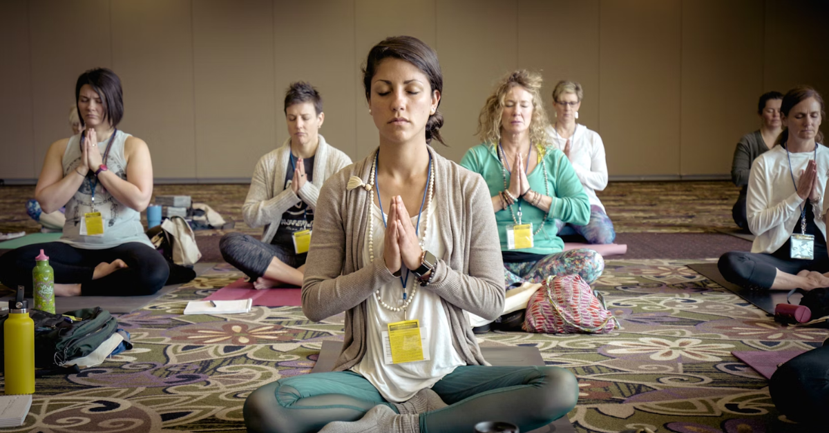 people sitting Indian-style while meditating