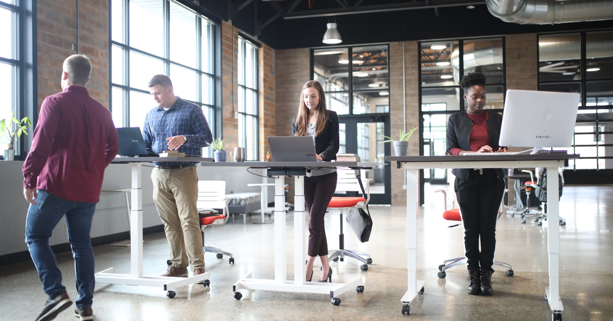 Employees working on a standing desk