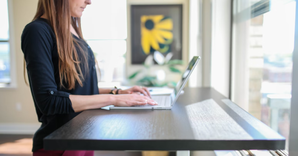 Girl working on a walnut standing desk