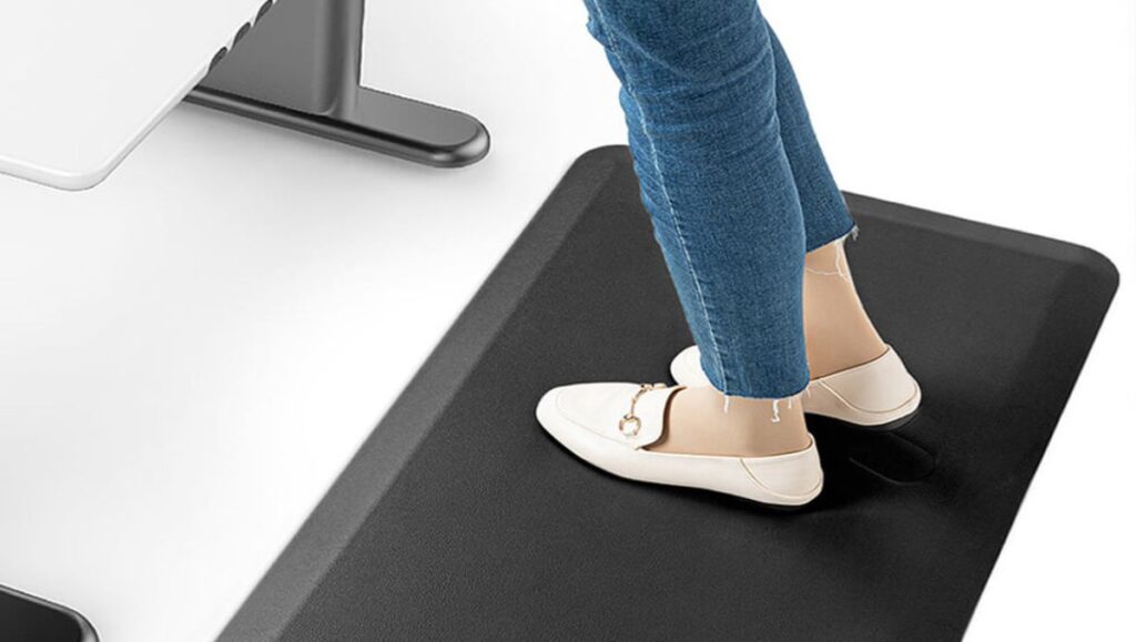 standing desk exercise equipment Girl's feet standing on an anti-fatigue mat