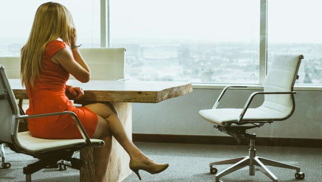 Woman wearing red dress sitting in the office chair