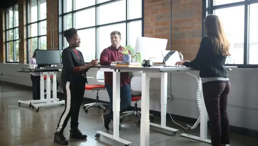 Office workers using standing desk