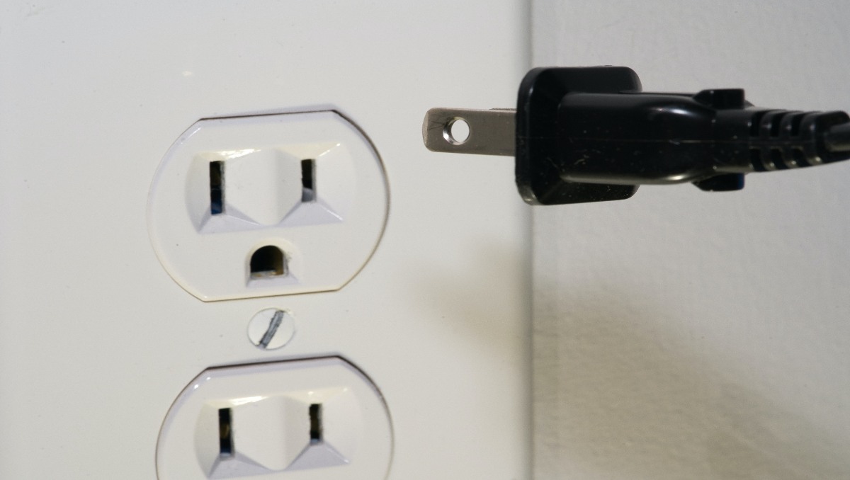 A close-up of an electrical outlet and plug.