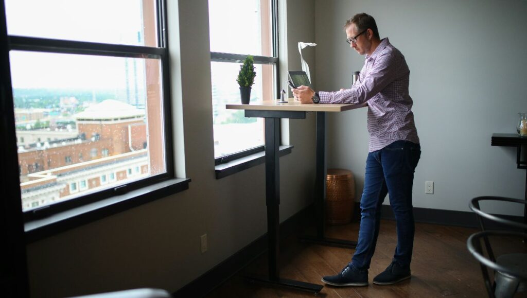 Man using laptop on a standing desk