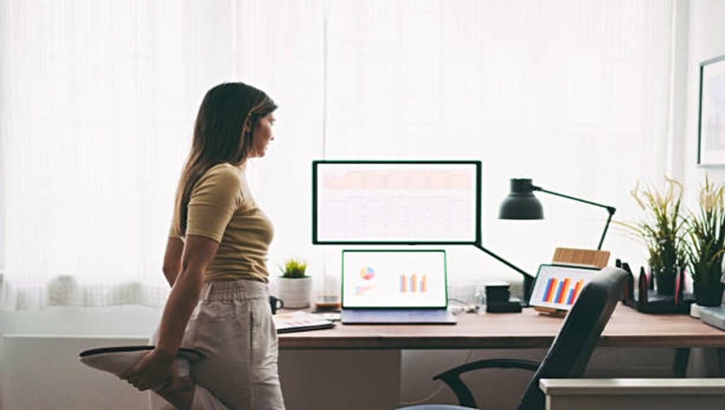 Girl stretching in front of office table.