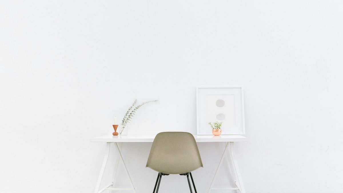 Minimalist white desk and brown chair