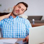 Male worker having neck pain