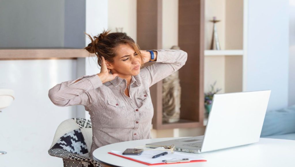 Girl in the office having a neck pain