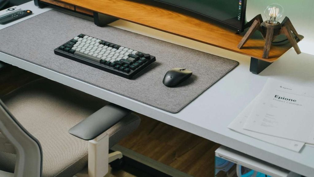 A keyboard and a mouse on a desk mat