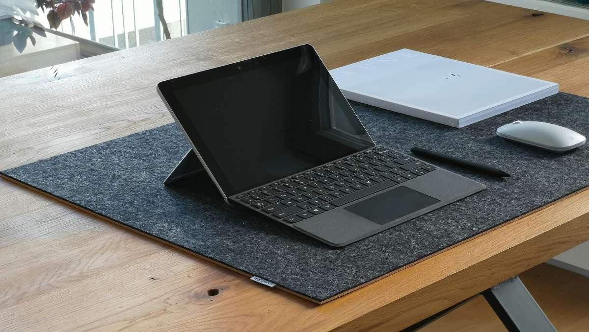 Laptop on a large desk mat