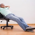 Man leaning backward his office chair