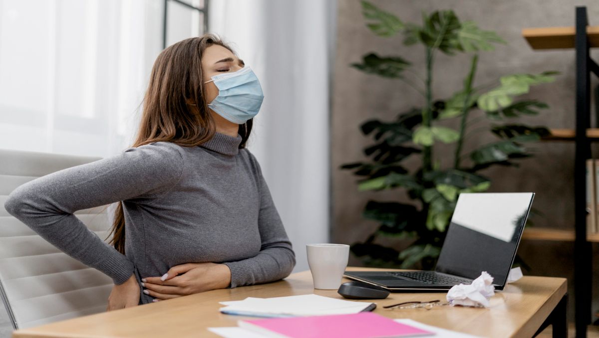 Girl having back pain and health effects in the office