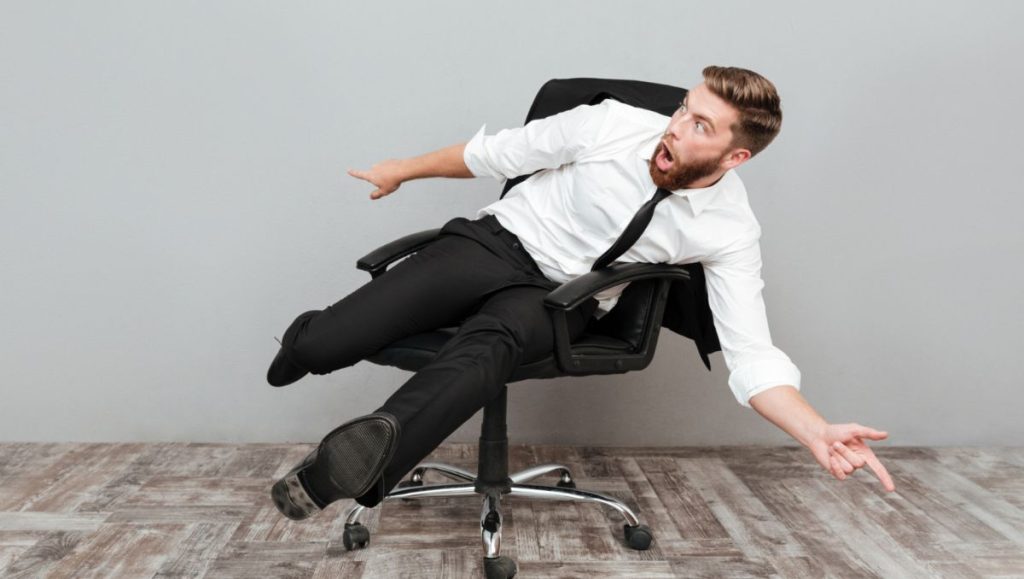 Man falling off in sinking office chair