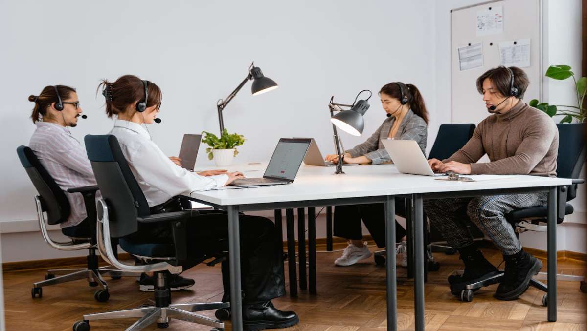 Four workers sitting in office chair