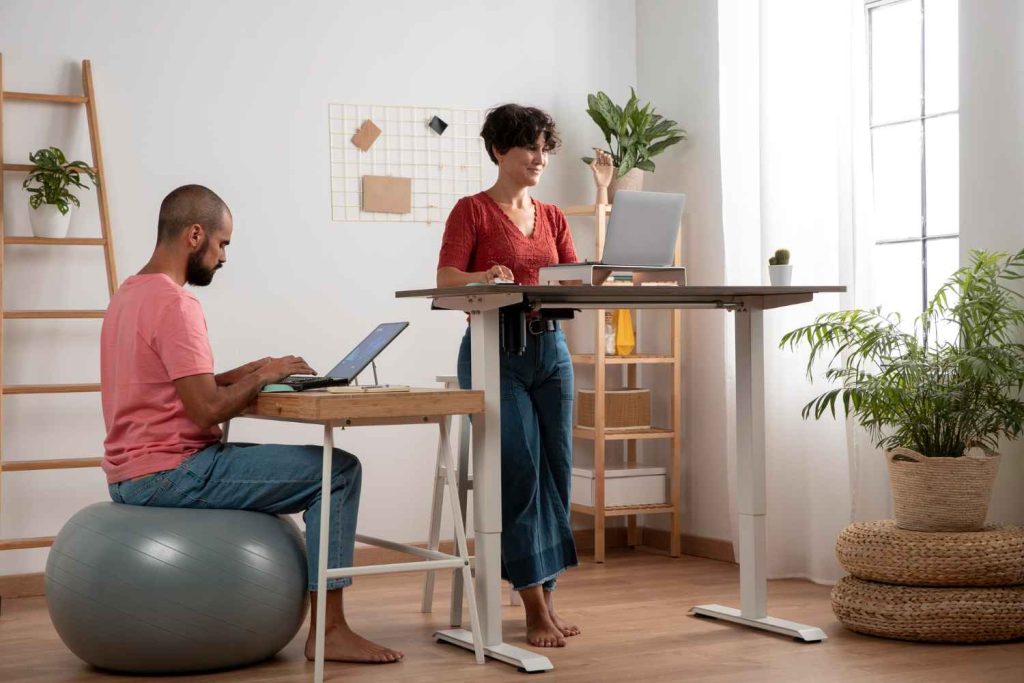 office chair stretches Girl working on a standing desk and guy sitting on balance ball chair