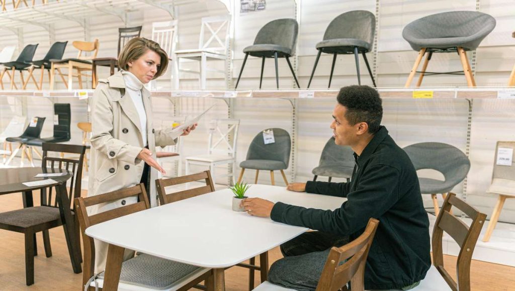 Man and woman talking in furniture store