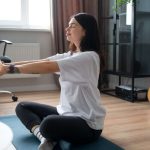 Girl stretching on the floor beside the office chair