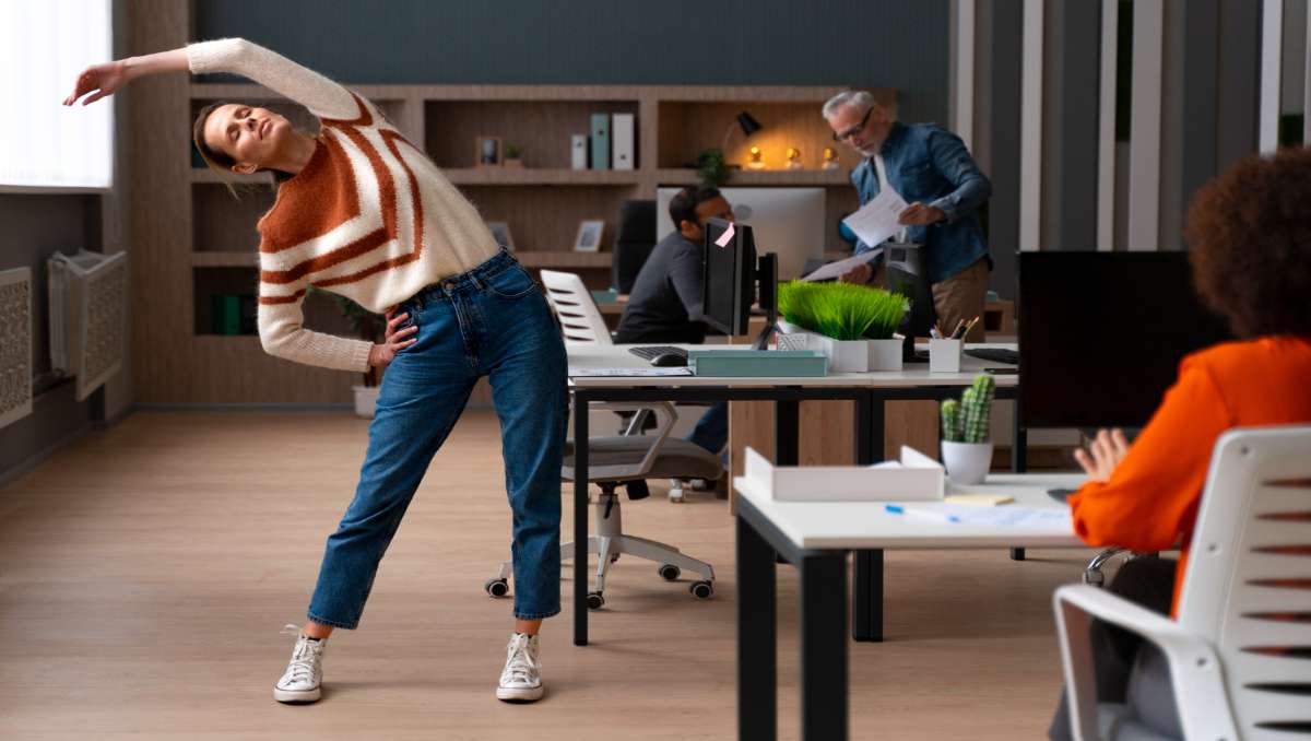 Woman at the office stretching during the workday