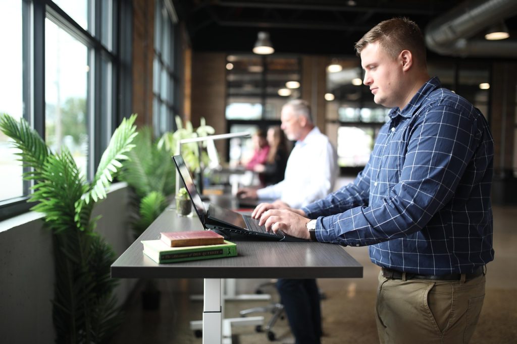 standing desk error codes Man in blue working at the office using standing desk