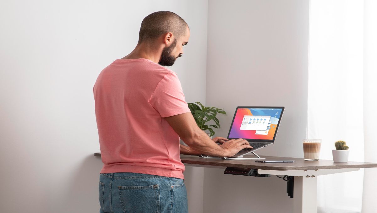 A man working from home using ergonomic amish desk