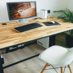 Amish wooden desk setup at home with white chair and computer on top