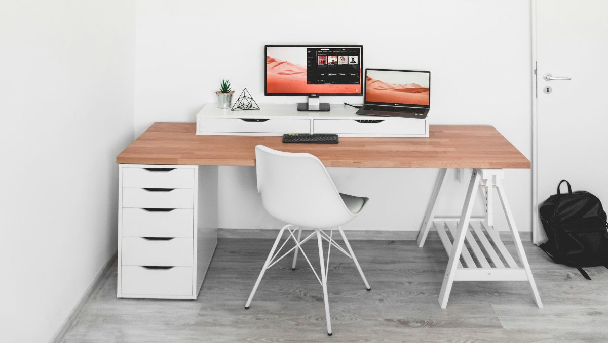 A bespoke wooden office table with white chair