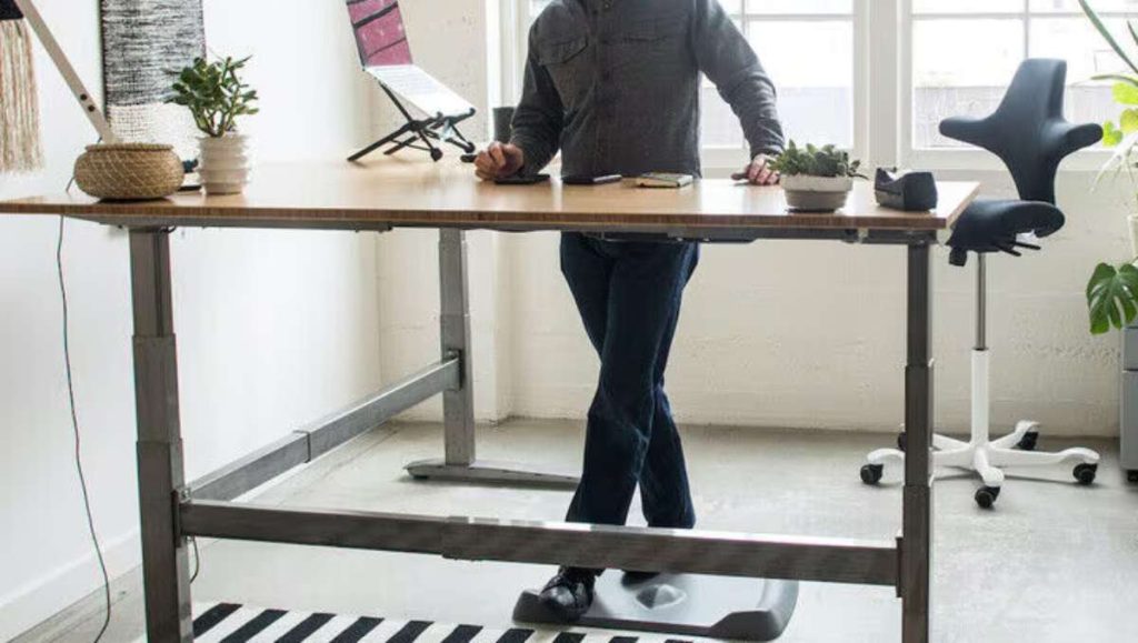 Man using jarvis standing desk