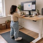 A short girl working on a standing desk