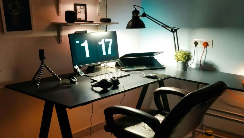 A corner desk setup with lighting