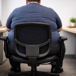 Heavy office worker in ergonomic chair