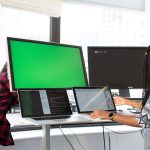 Two woman working on a standing desk