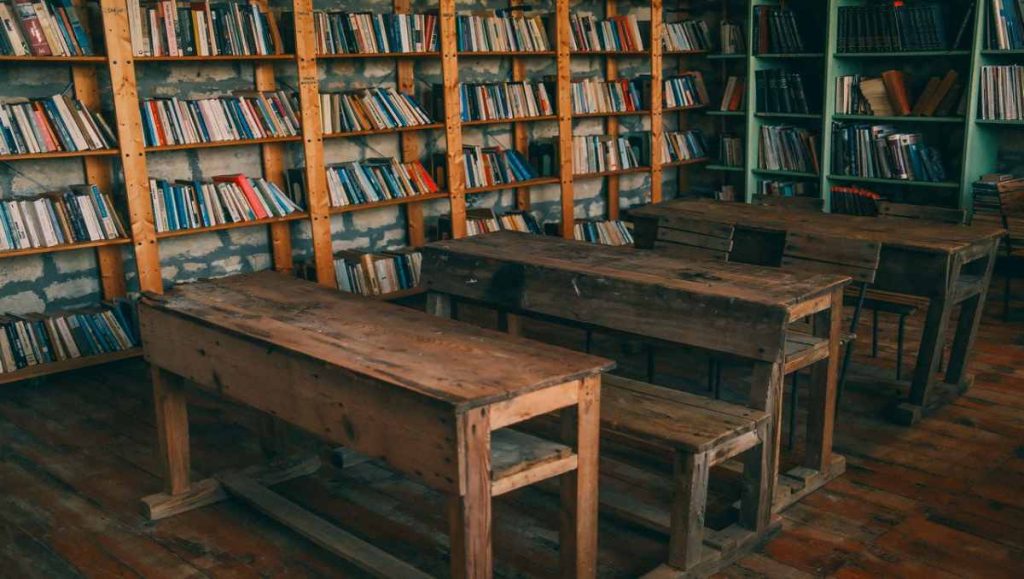Classroom with wooden desk and bookshelves