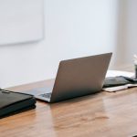 Wooden desk with laptop on top