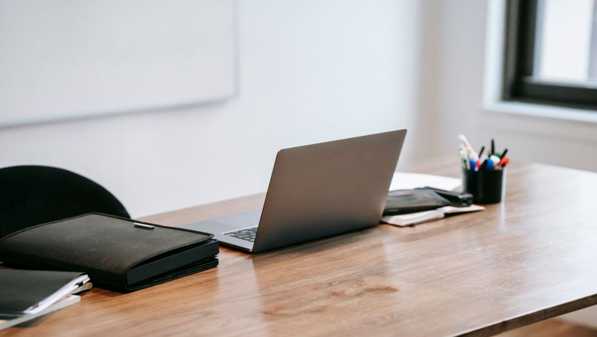 Wooden desk with laptop on top