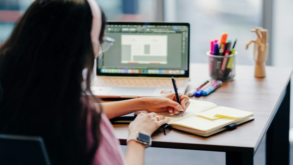 Girl student writing on a desk 